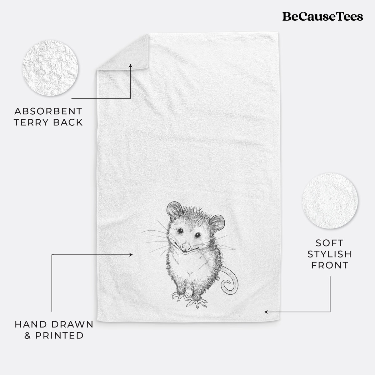 White hand towel printed with a black ink illustration of a wide-eyed baby opossum sitting.