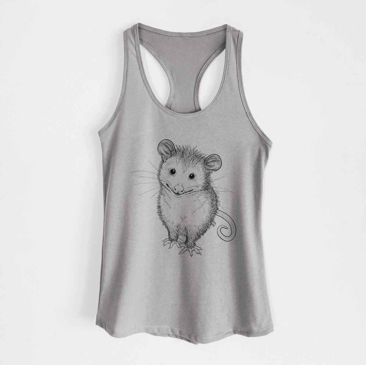 Heather grey women's racerback tank top laid flat, printed with a black ink illustration of a wide-eyed baby opossum sitting.