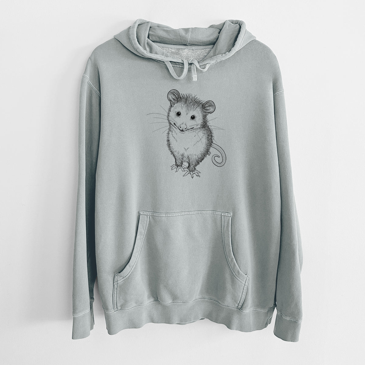 Sage green pigment dyed hoodie laid flat, printed with a black ink illustration of a wide-eyed baby opossum sitting.