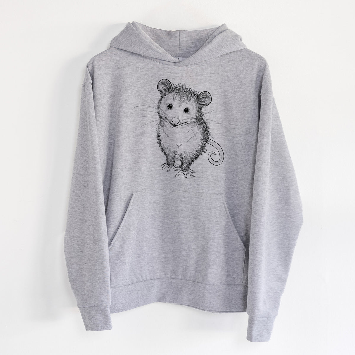 Cute Opossum - Statement Midweight Hoodie in Heather Grey, hanging on a white wall, with a front kangaroo pocket and no drawcords.