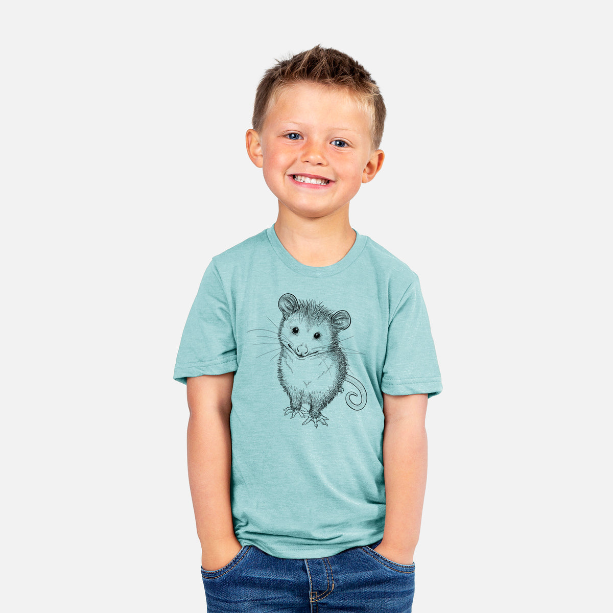 Smiling boy wearing a youth t-shirt printed with a black ink illustration of a wide-eyed baby opossum sitting.