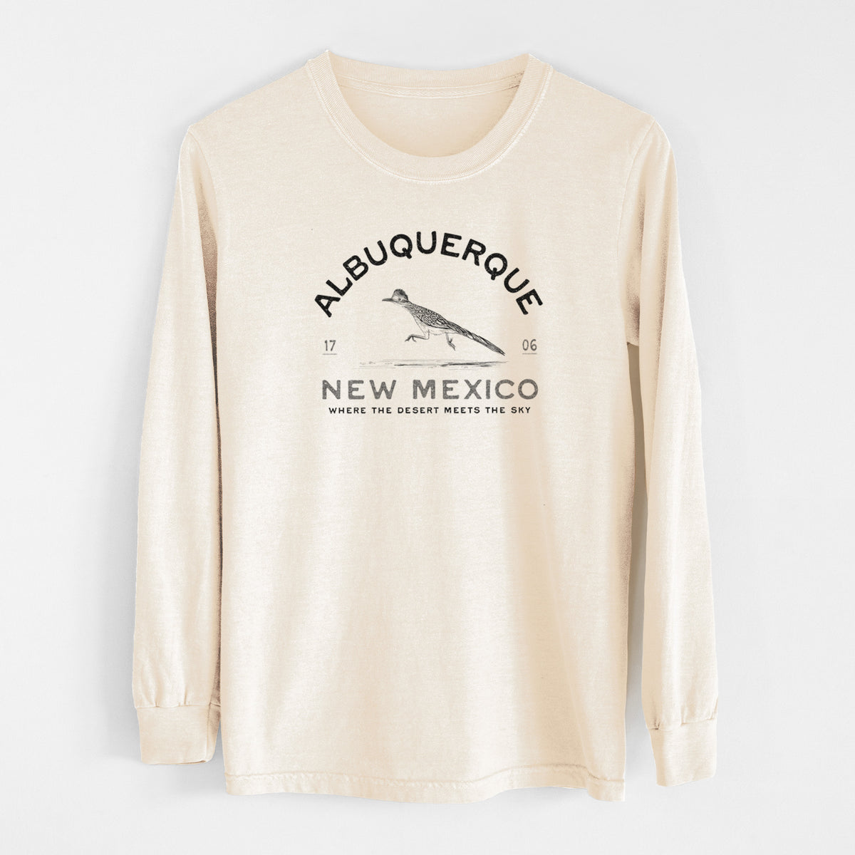 Ivory Comfort Colors long sleeve shirt laid flat, printed with a black ink roadrunner with the words Albuquerque New Mexico, 1706, Where the Desert Meets the Sky.