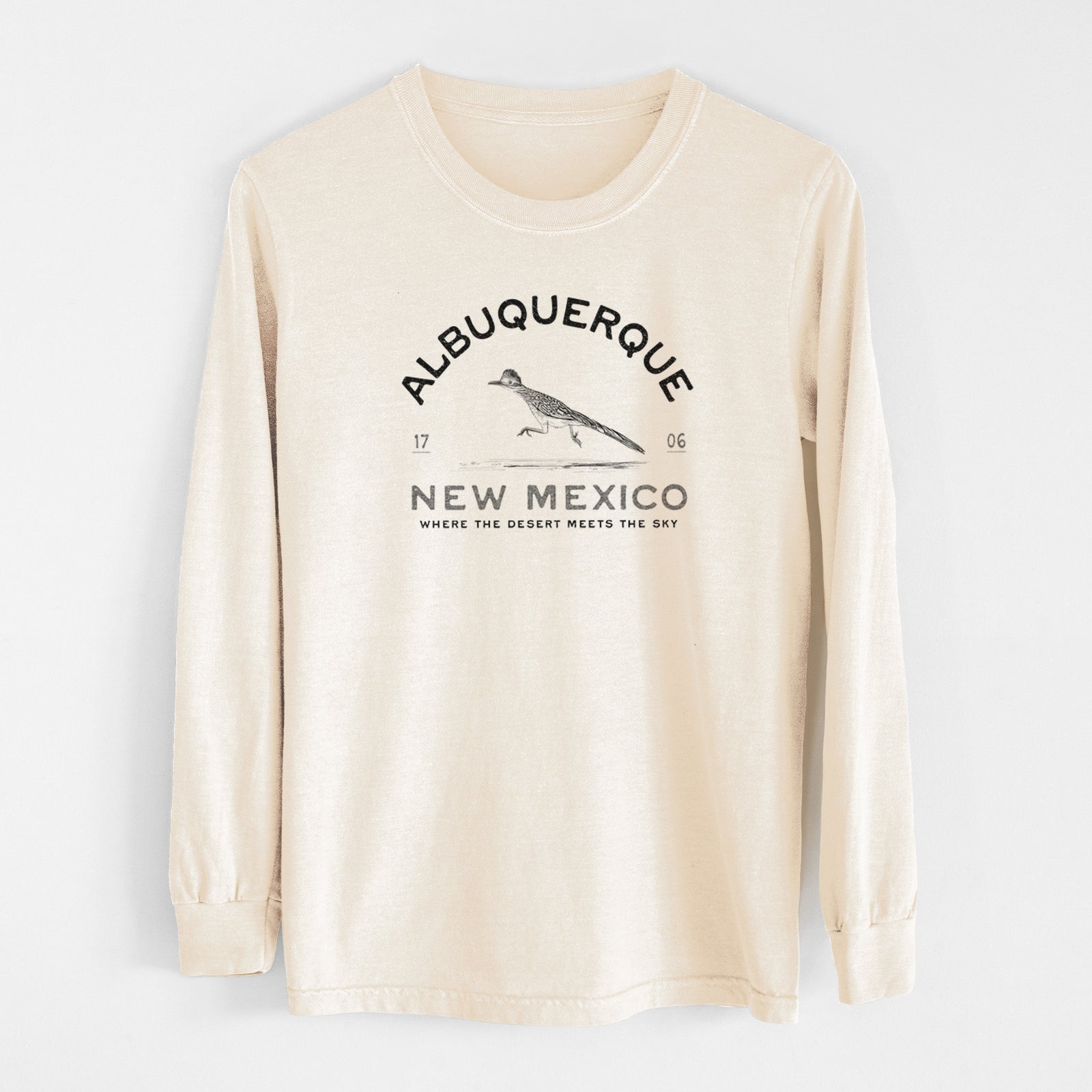 Ivory Comfort Colors long sleeve shirt laid flat, printed with a black ink roadrunner with the words Albuquerque New Mexico, 1706, Where the Desert Meets the Sky.