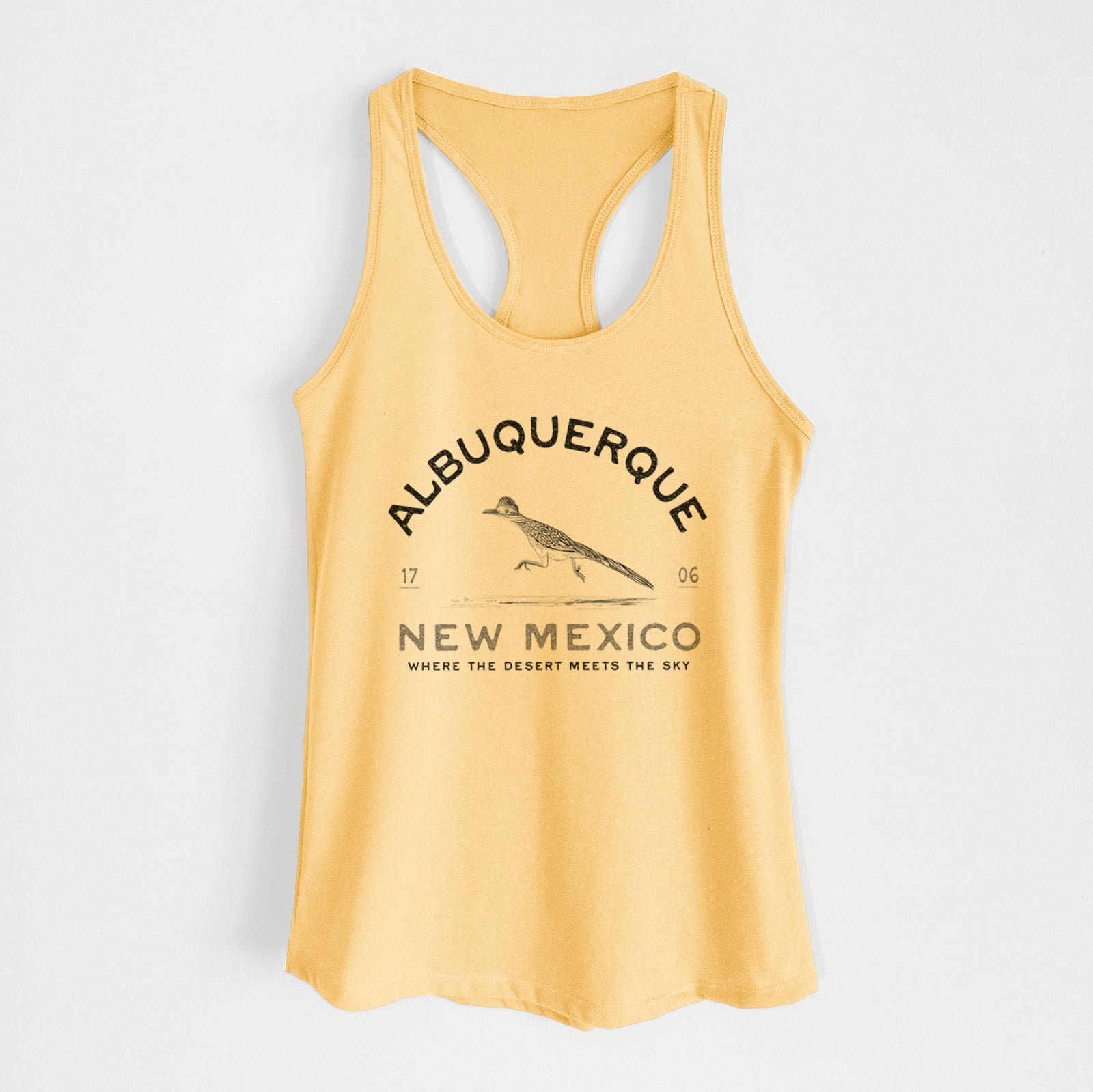 Banana cream women's racerback tank top laid flat, printed with a black ink roadrunner with the words Albuquerque New Mexico, 1706, Where the Desert Meets the Sky.