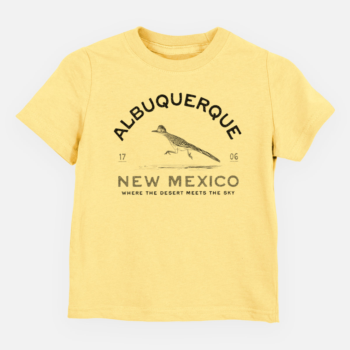 Butter yellow toddler t-shirt laid flat, printed with a black ink roadrunner with the words Albuquerque New Mexico, 1706, Where the Desert Meets the Sky.