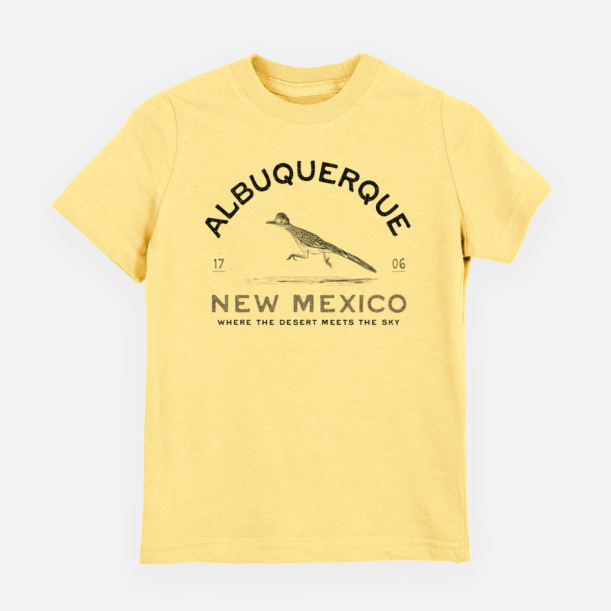 Butter yellow youth t-shirt laid flat, printed with a black ink roadrunner with the words Albuquerque New Mexico, 1706, Where the Desert Meets the Sky.