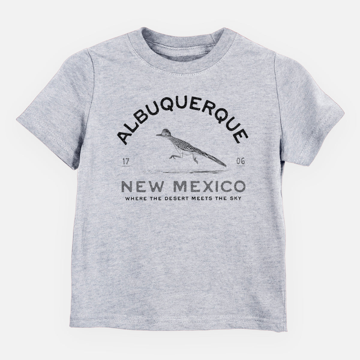 Heather grey toddler t-shirt laid flat, printed with a black ink roadrunner with the words Albuquerque New Mexico, 1706, Where the Desert Meets the Sky.
