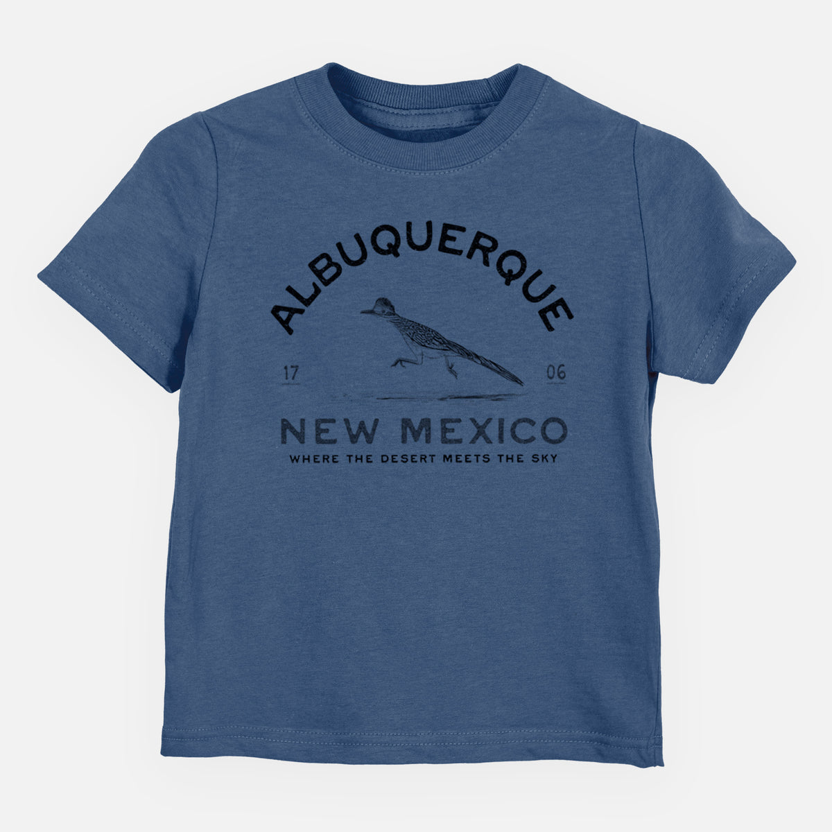 Indigo blue toddler t-shirt laid flat, printed with a black ink roadrunner with the words Albuquerque New Mexico, 1706, Where the Desert Meets the Sky.