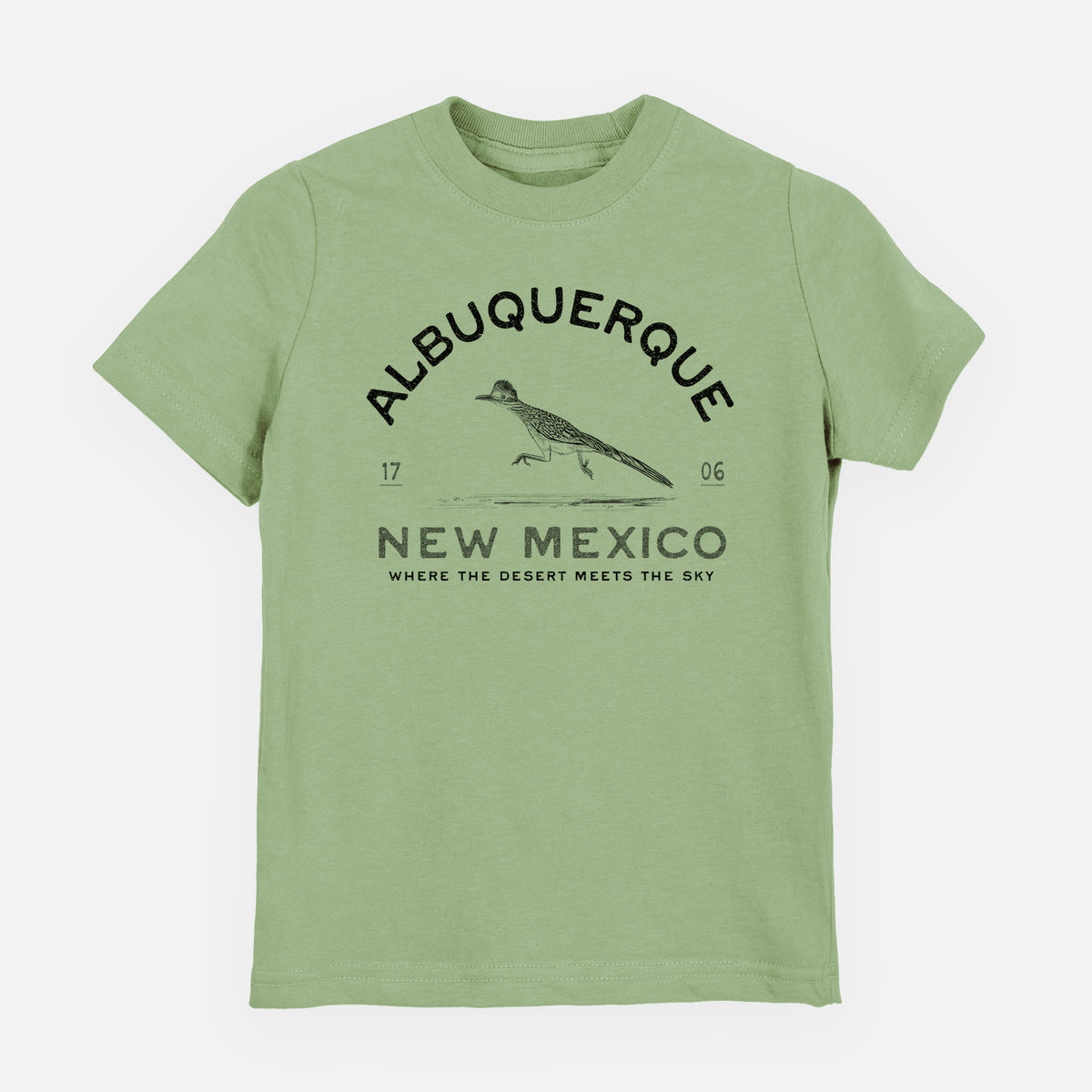 Sage green youth t-shirt laid flat, printed with a black ink roadrunner with the words Albuquerque New Mexico, 1706, Where the Desert Meets the Sky.