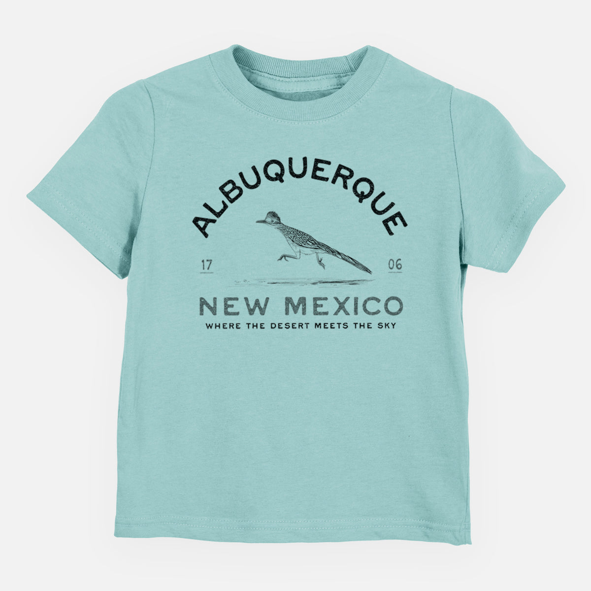 Saltwater toddler t-shirt laid flat, printed with a black ink roadrunner with the words Albuquerque New Mexico, 1706, Where the Desert Meets the Sky.