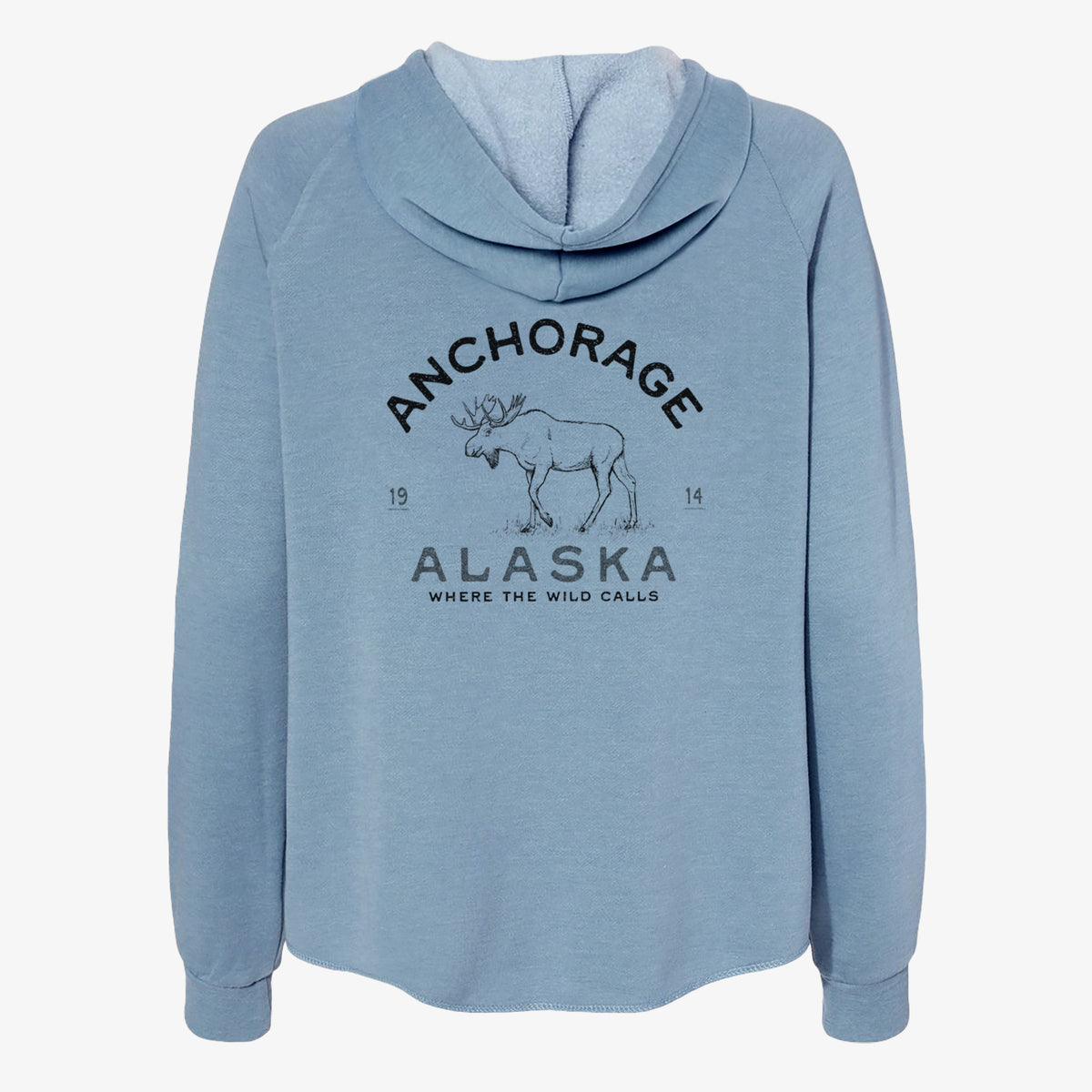 Misty blue women's Cali Wave zip-up sweatshirt laid flat, printed with a black ink moose with the words Anchorage Alaska, 1914, Where the Wild Calls.