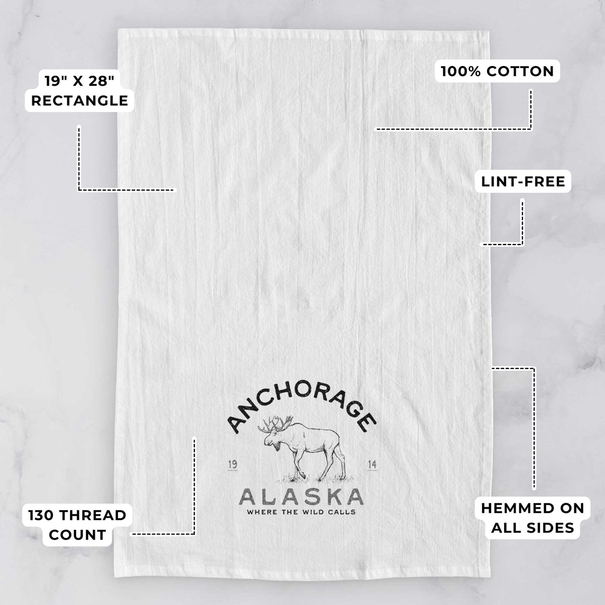 White tea towel printed with a black ink moose with the words Anchorage Alaska, 1914, Where the Wild Calls, with feature labels: 19 by 28 inch rectangle, 100% cotton, lint-free, 130 thread count, hemmed on all sides.