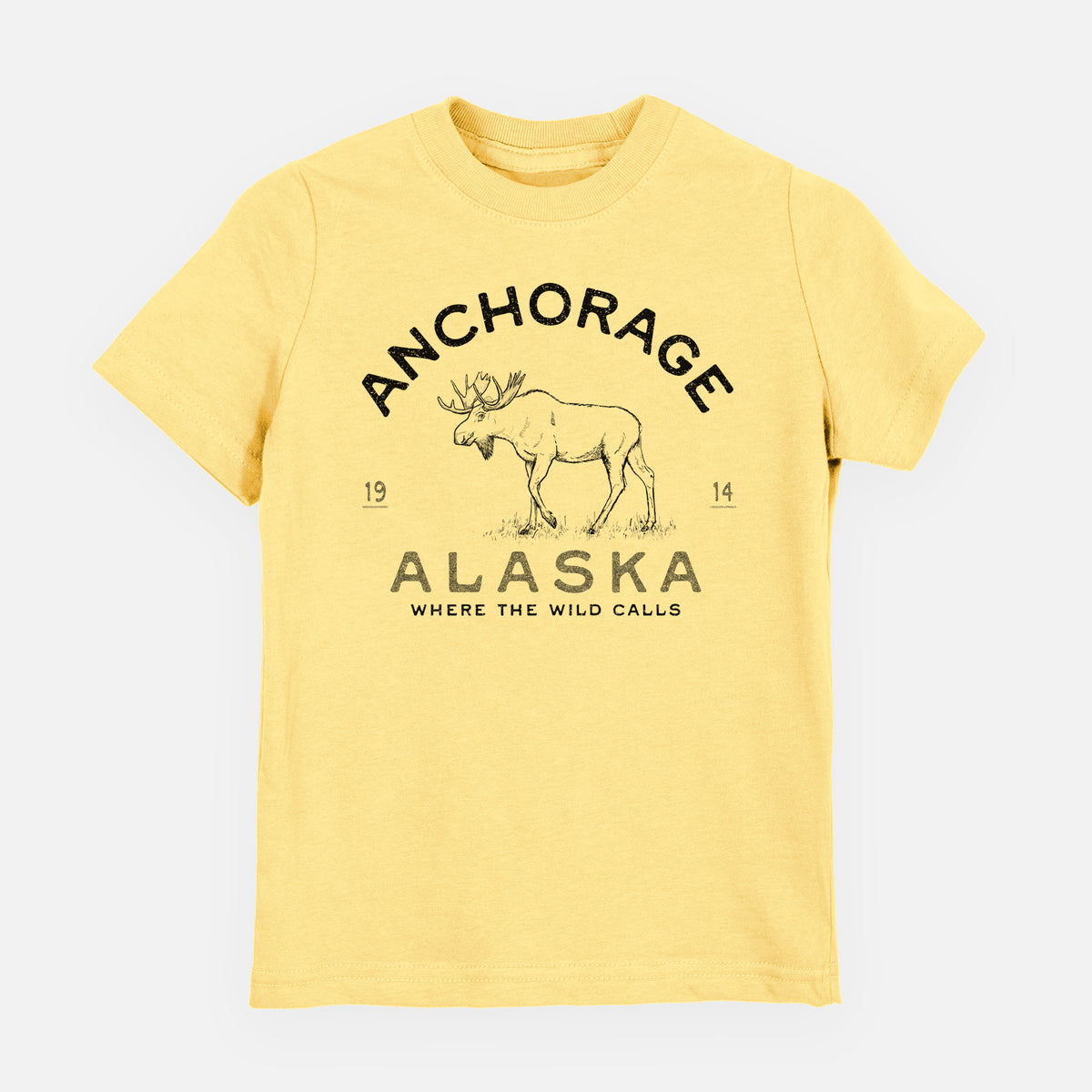 Butter yellow youth t-shirt laid flat, printed with a black ink moose with the words Anchorage Alaska, 1914, Where the Wild Calls.