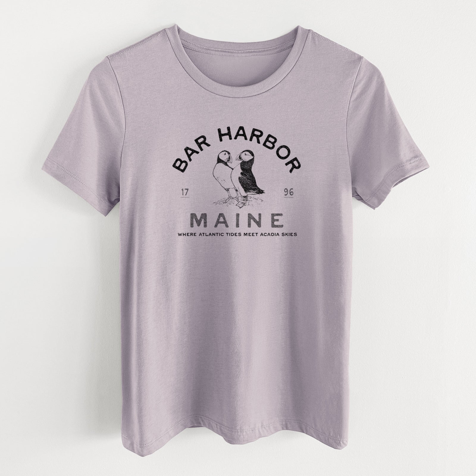 Light violet women's relaxed fit cotton t-shirt laid flat, printed with two black ink puffins with the words Bar Harbor Maine, 1796, Where Atlantic Tides Meet Acadia Skies.