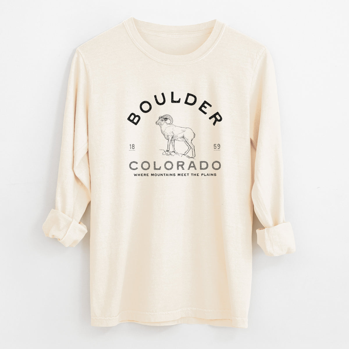 Ivory Comfort Colors long sleeve shirt laid flat with the cuffs rolled, printed with a black ink bighorn sheep with the words Boulder Colorado, Where Mountains Meet the Plains, 1859.
