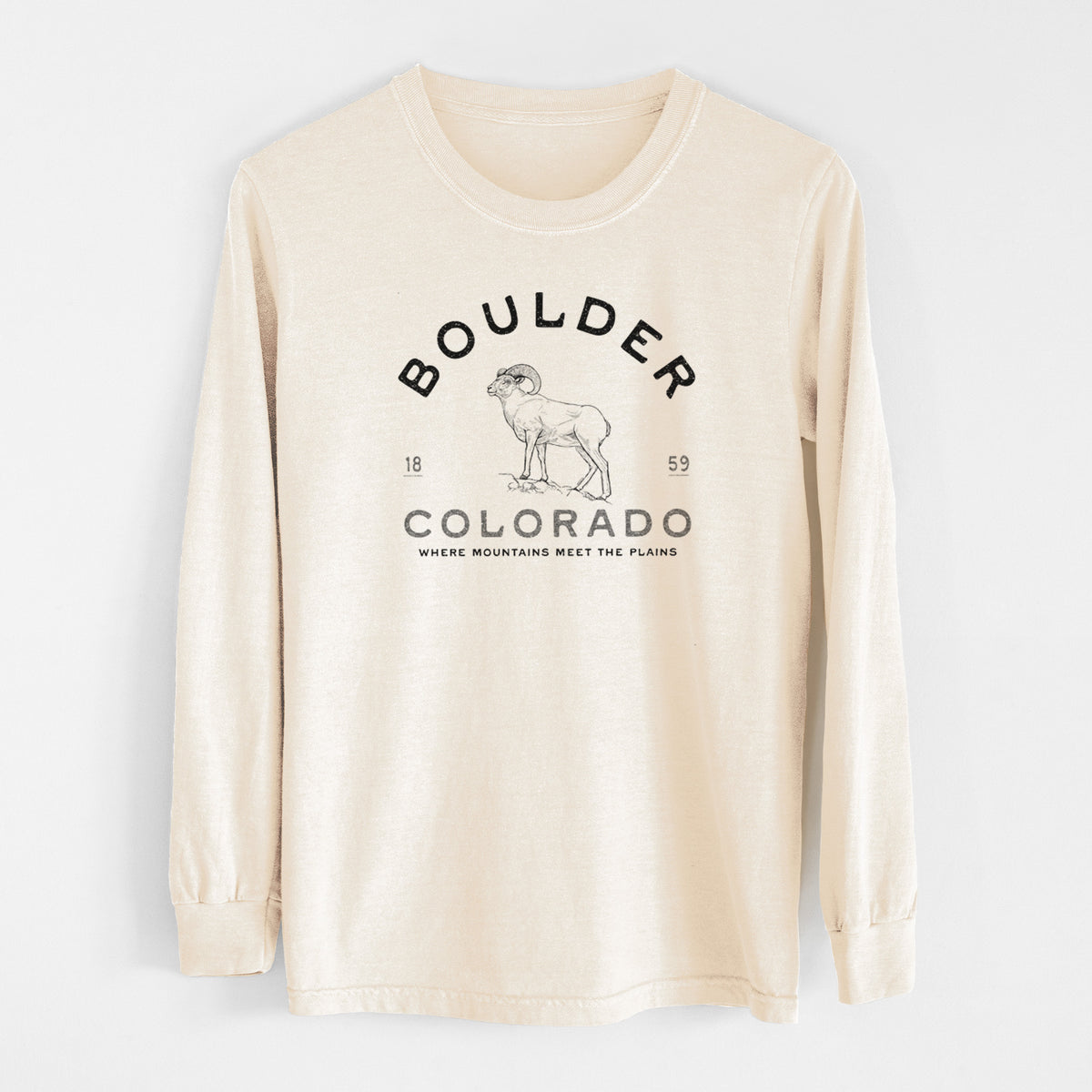 Ivory Comfort Colors long sleeve shirt laid flat, printed with a black ink bighorn sheep with the words Boulder Colorado, Where Mountains Meet the Plains, 1859.