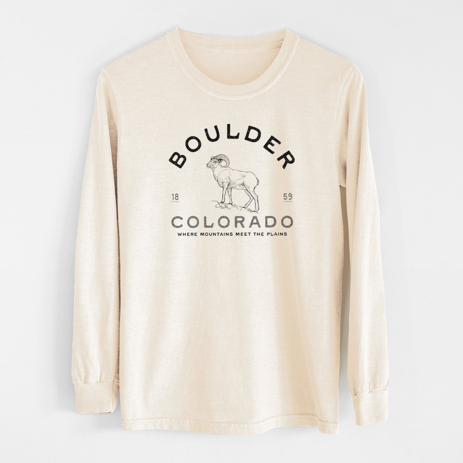 Ivory Comfort Colors long sleeve shirt laid flat, printed with a black ink bighorn sheep with the words Boulder Colorado, Where Mountains Meet the Plains, 1859.