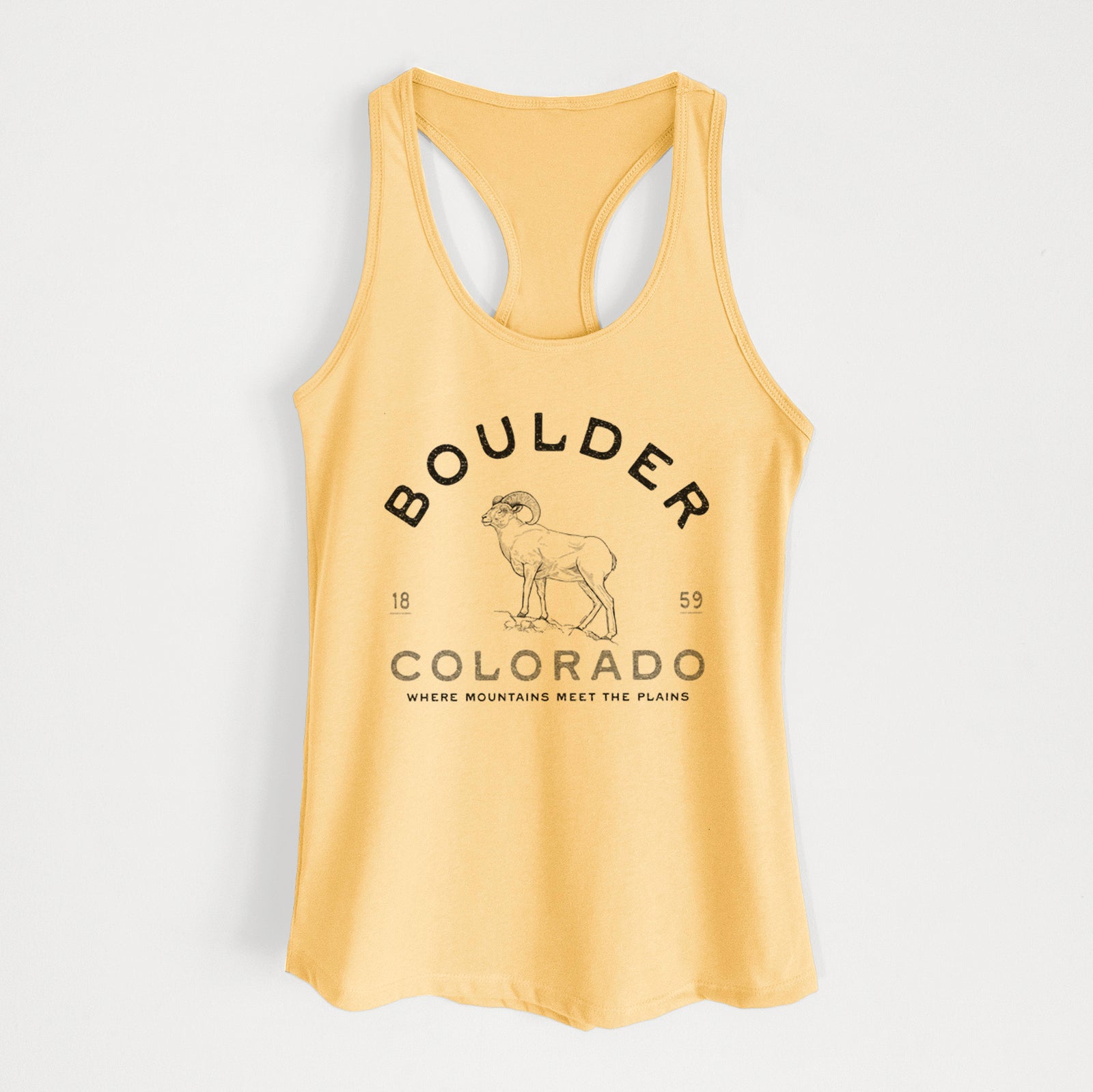 Banana cream women's racerback tank top laid flat, printed with a black ink bighorn sheep with the words Boulder Colorado, Where Mountains Meet the Plains, 1859.