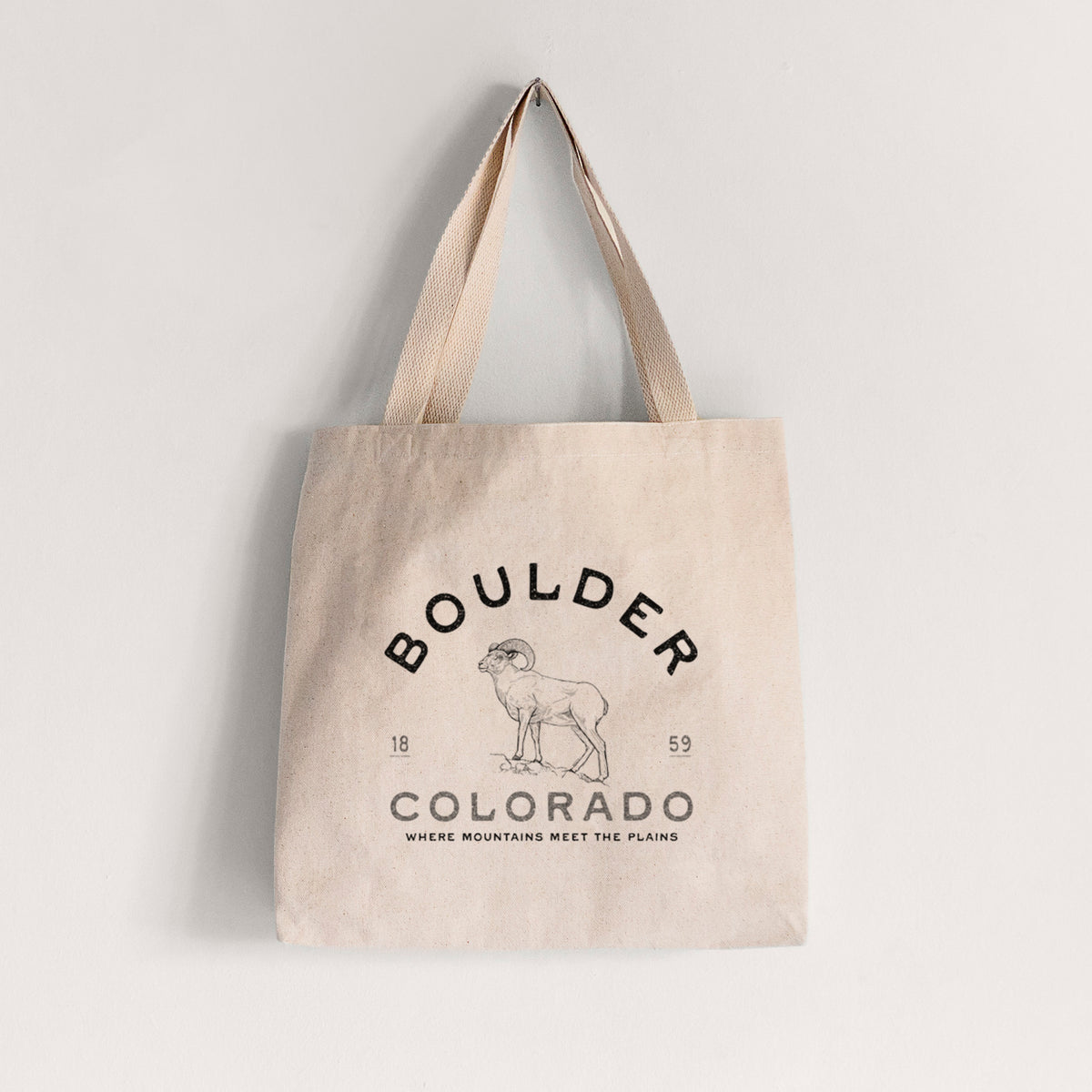Natural canvas tote bag printed with a black ink bighorn sheep with the words Boulder Colorado, Where Mountains Meet the Plains, 1859.