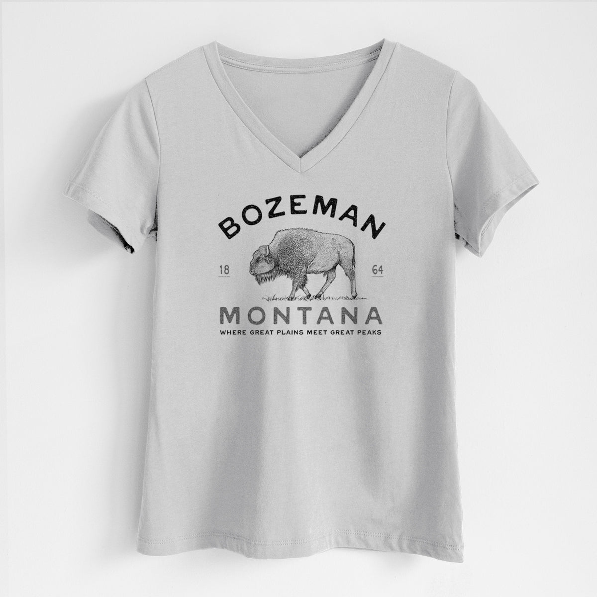 Lunar grey women's relaxed fit cotton V-neck t-shirt laid flat, printed with a black ink bison with the words Bozeman Montana, 1864, Where Great Plains Meet Great Peaks.