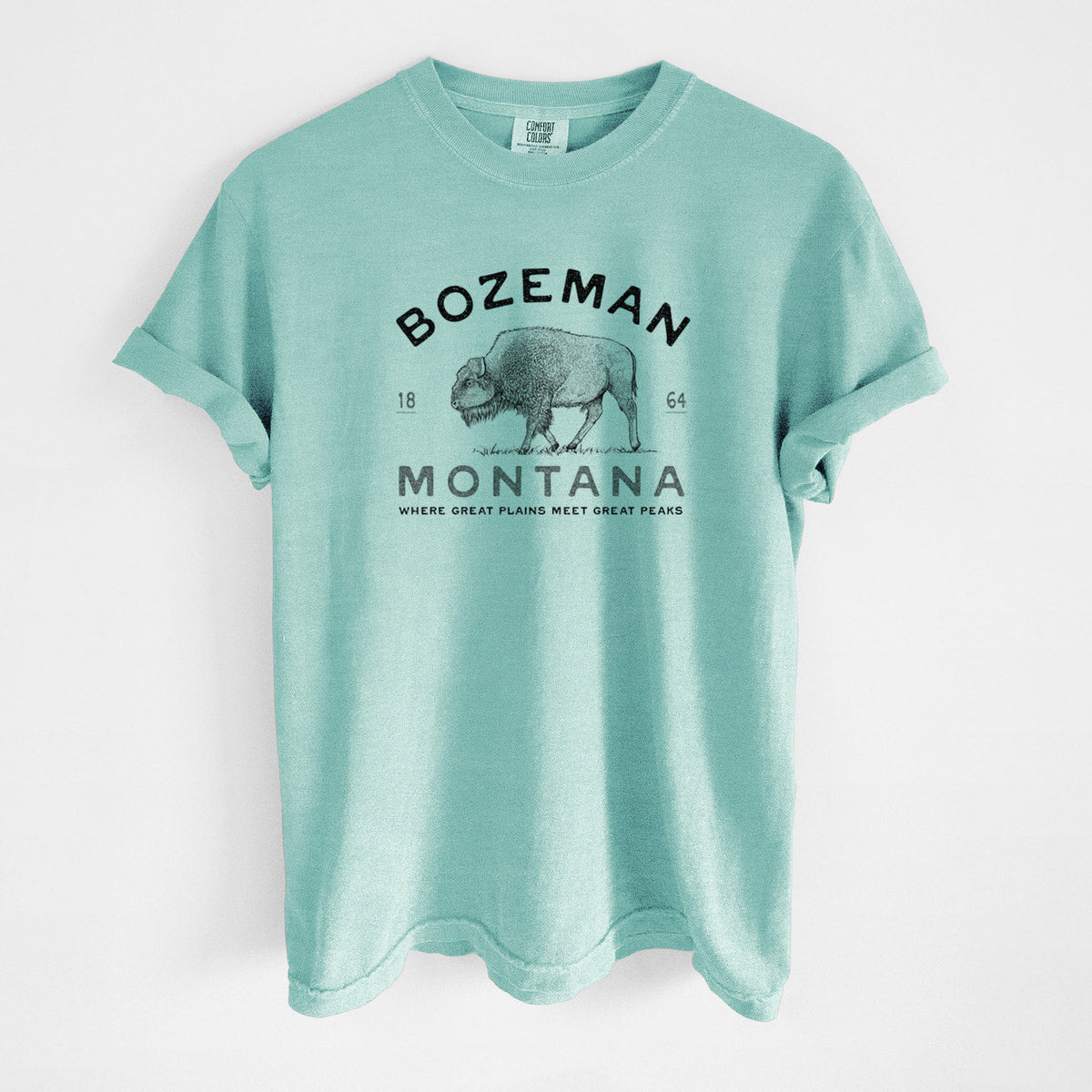Chalky mint Comfort Colors t-shirt laid flat, printed with a black ink bison with the words Bozeman Montana, 1864, Where Great Plains Meet Great Peaks.
