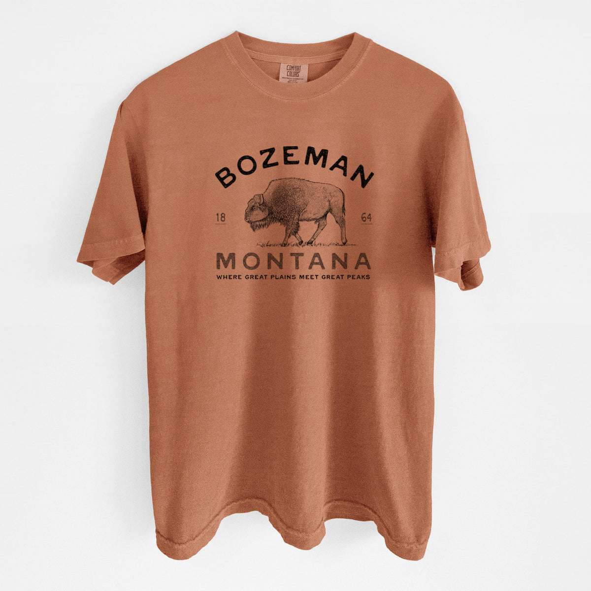 Yam burnt orange Comfort Colors t-shirt laid flat, printed with a black ink bison with the words Bozeman Montana, 1864, Where Great Plains Meet Great Peaks.
