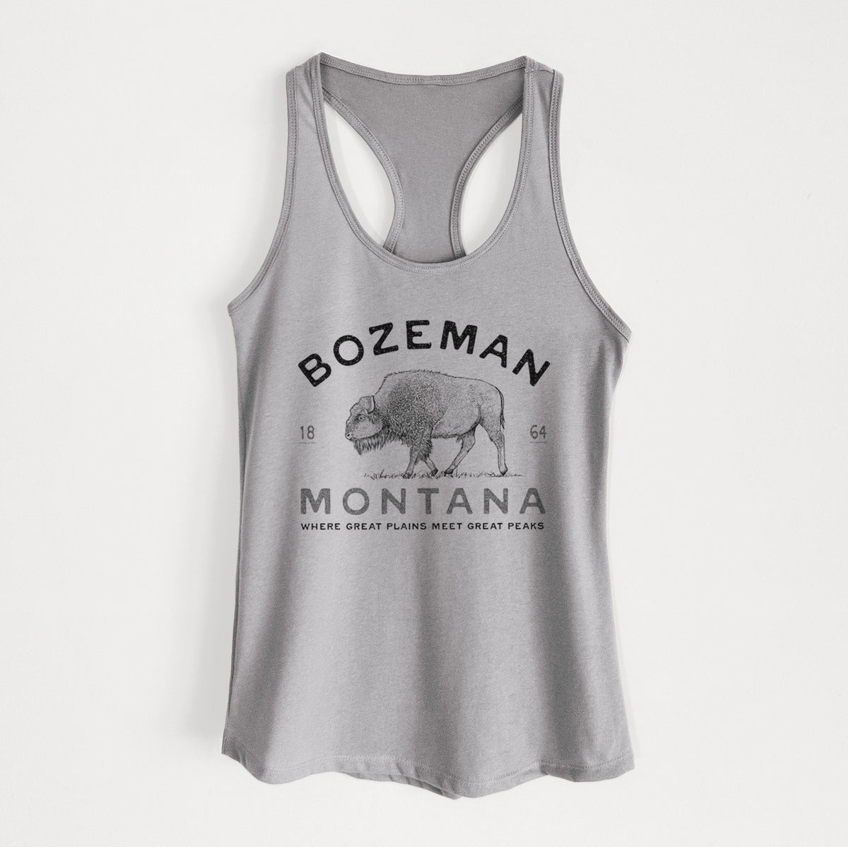 Heather grey women's racerback tank top laid flat, printed with a black ink bison with the words Bozeman Montana, 1864, Where Great Plains Meet Great Peaks.
