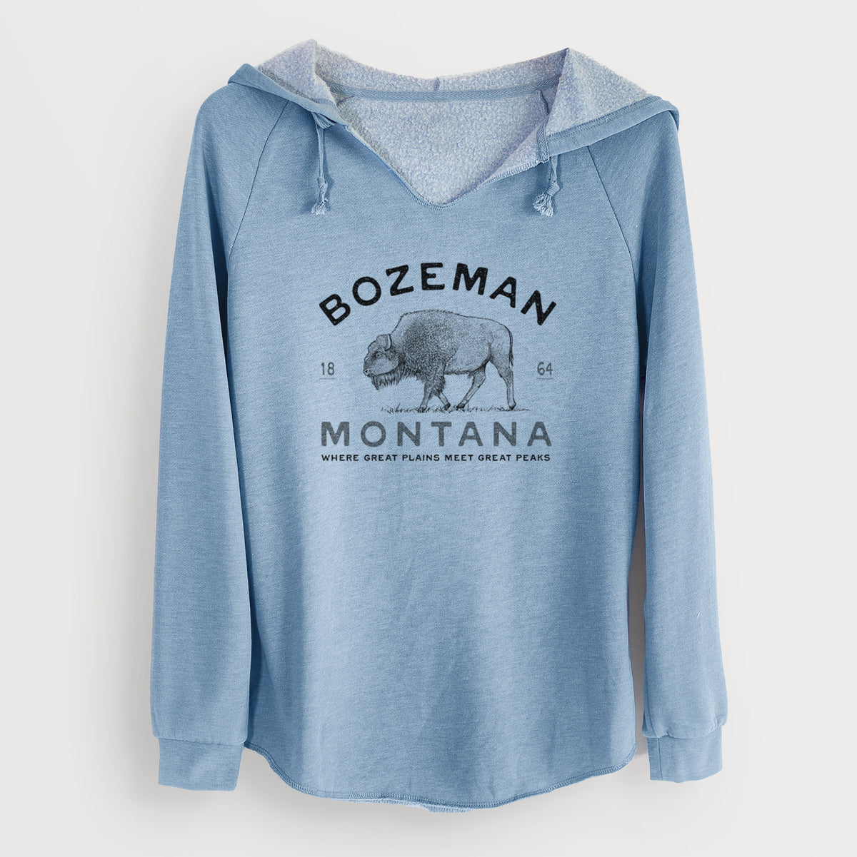 Misty blue women's Cali Wave hooded sweatshirt laid flat, printed with a black ink bison with the words Bozeman Montana, 1864, Where Great Plains Meet Great Peaks.