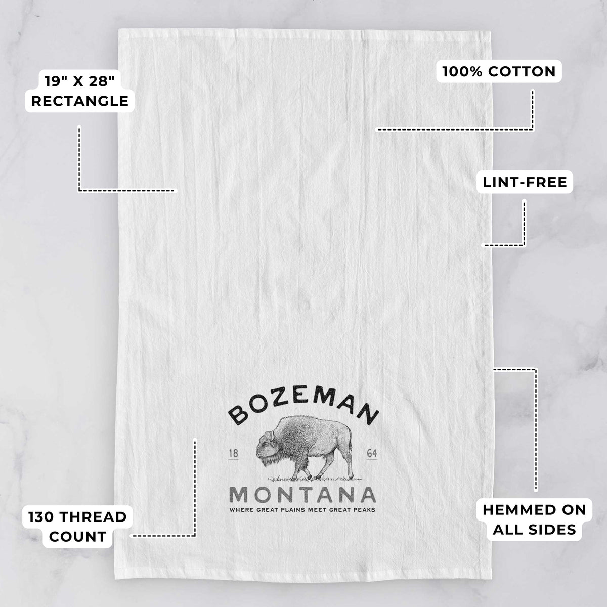 White tea towel printed with a black ink bison with the words Bozeman Montana, 1864, Where Great Plains Meet Great Peaks, with feature labels: 19 by 28 inch rectangle, 100% cotton, lint-free, 130 thread count, hemmed on all sides.