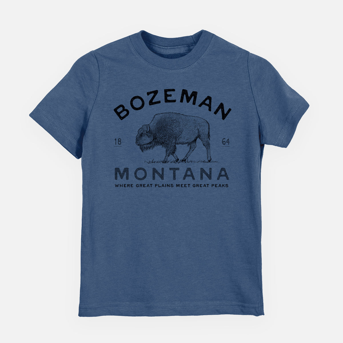 Indigo blue youth t-shirt laid flat, printed with a black ink bison with the words Bozeman Montana, 1864, Where Great Plains Meet Great Peaks.
