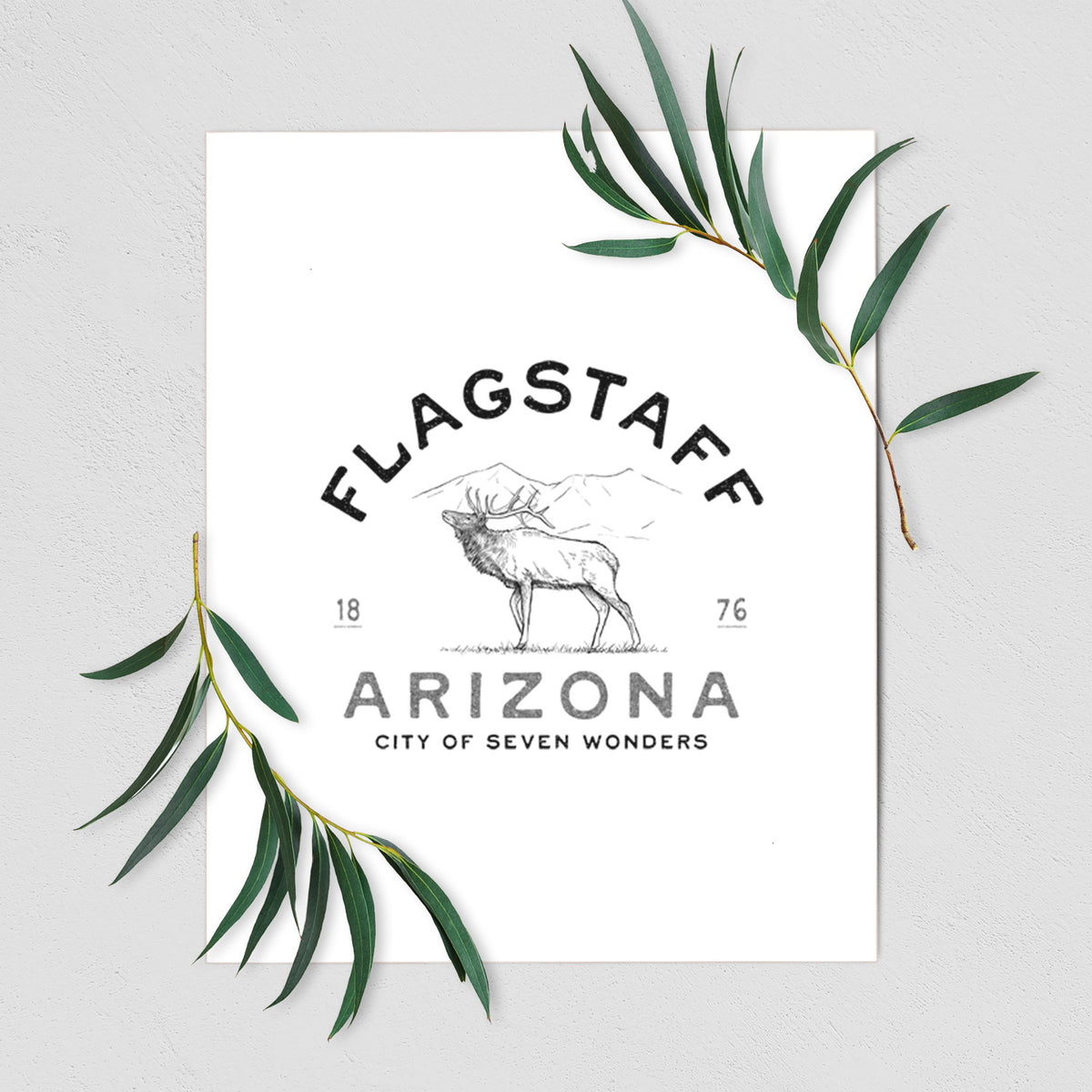 Art print of a black ink elk with the words Flagstaff Arizona, City of Seven Wonders, shown with eucalyptus leaves.