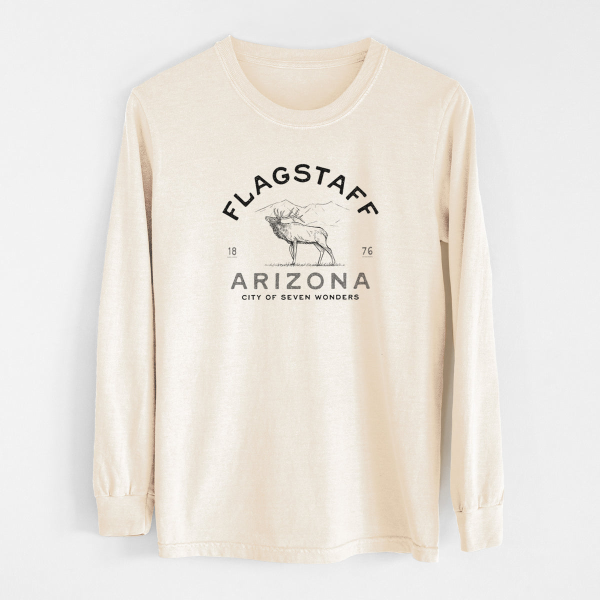 Ivory Comfort Colors long sleeve shirt laid flat, printed with a black ink elk with the words Flagstaff Arizona, City of Seven Wonders.