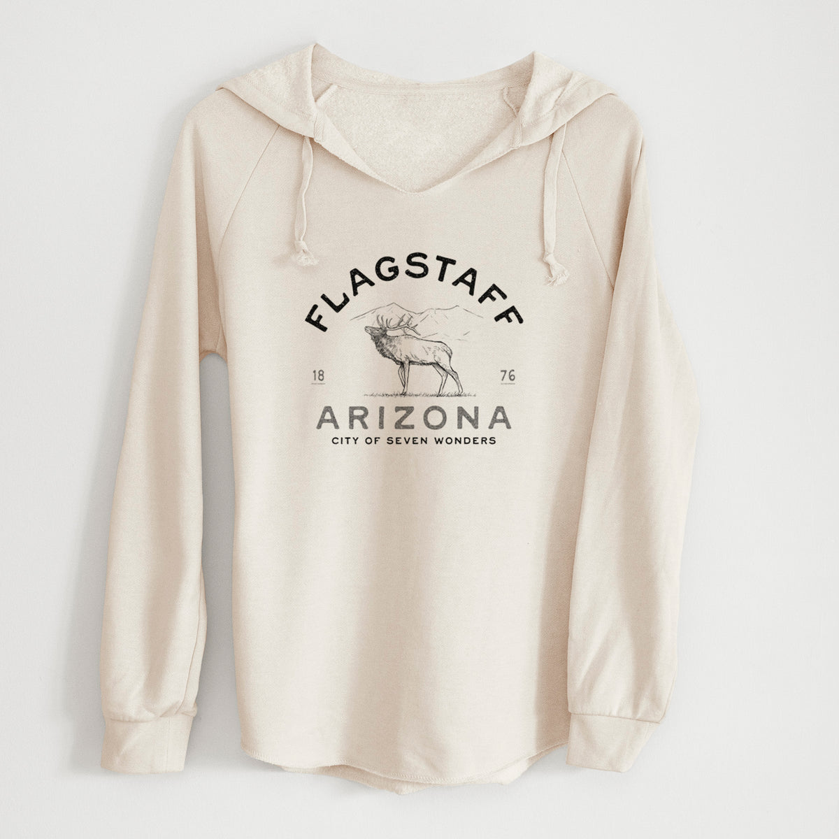 Bone cream women's Cali Wave hooded sweatshirt laid flat, printed with a black ink elk with the words Flagstaff Arizona, City of Seven Wonders.
