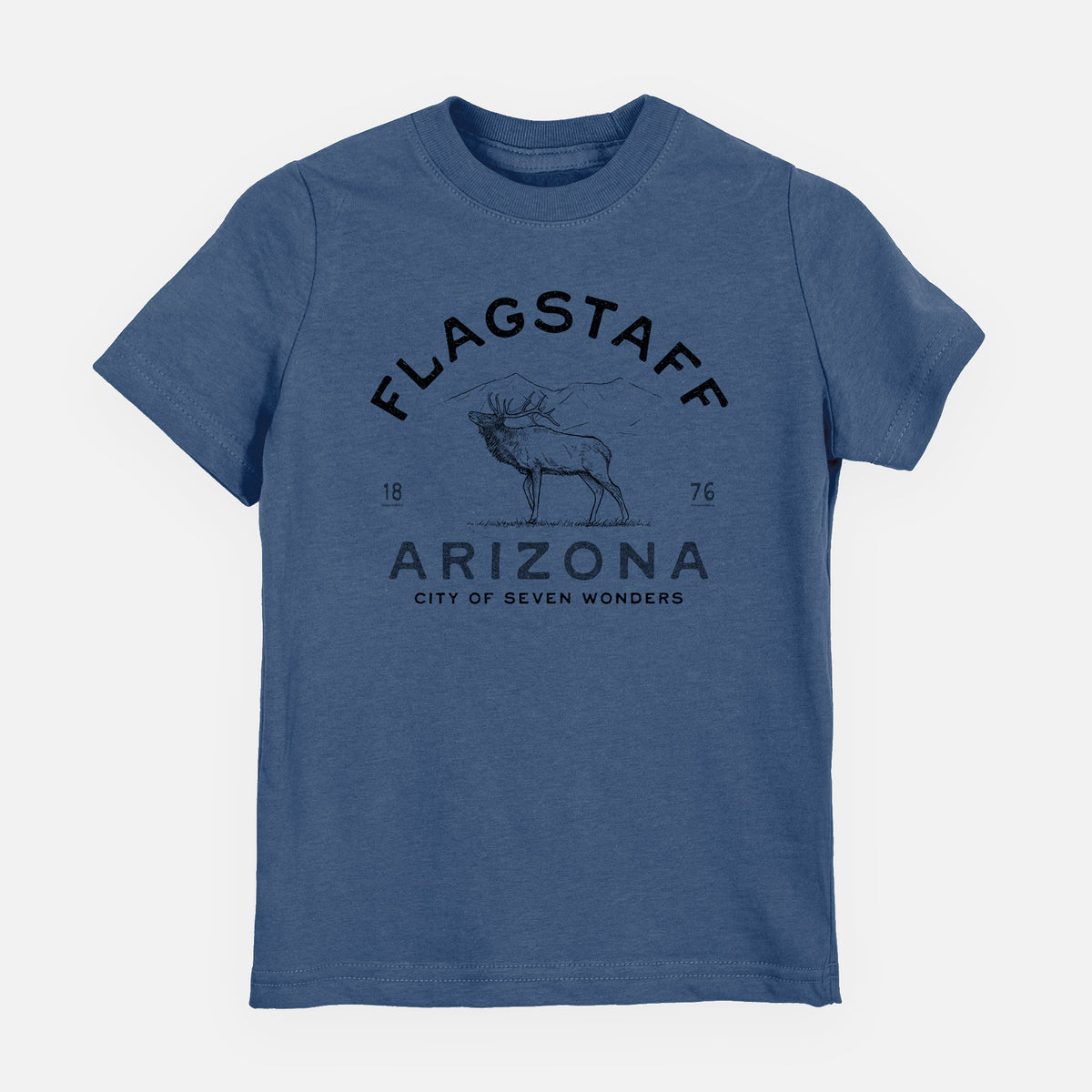 Indigo blue youth t-shirt laid flat, printed with a black ink elk with the words Flagstaff Arizona, City of Seven Wonders.
