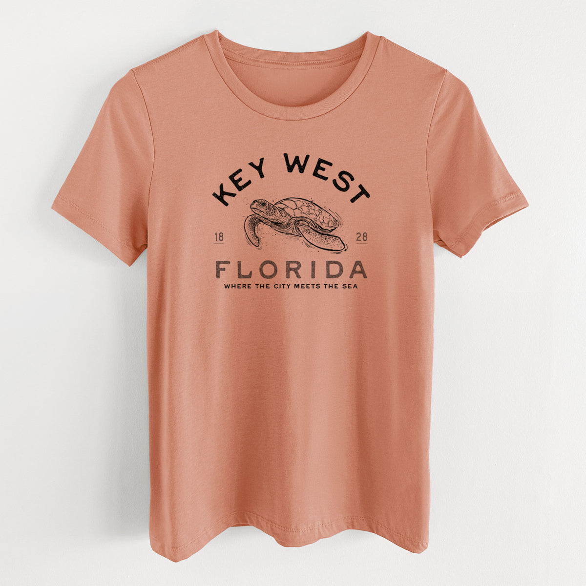 Terracotta orange women's relaxed fit cotton t-shirt laid flat, printed with a black ink sea turtle with the words Key West Florida.