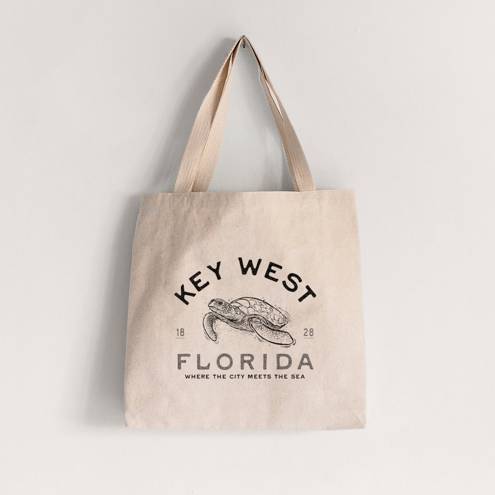 Natural canvas tote bag printed with a black ink sea turtle with the words Key West Florida.