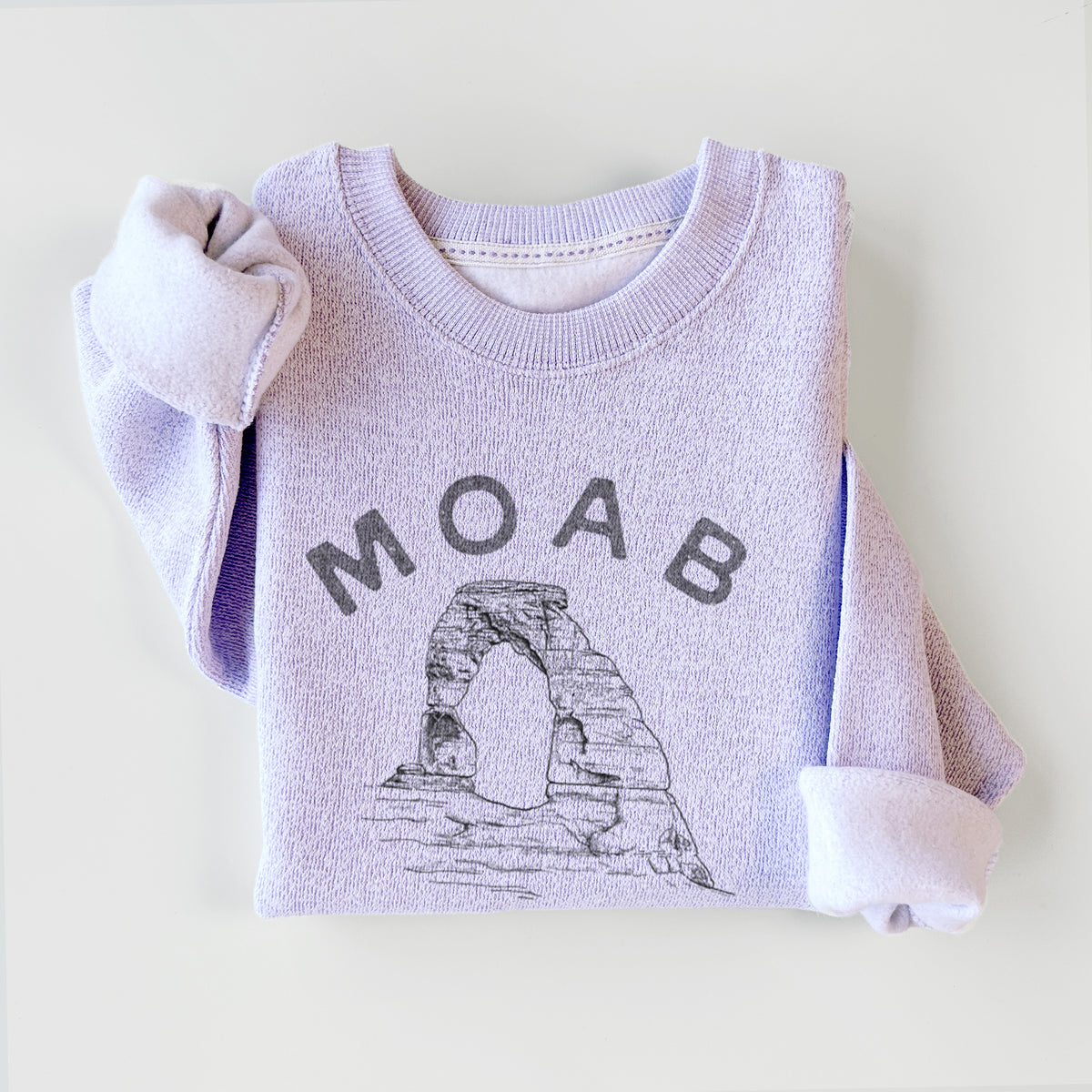 Ice purple knit sweatshirt printed with a black ink illustration of Delicate Arch with the words Moab Utah, 1878, styled flat.