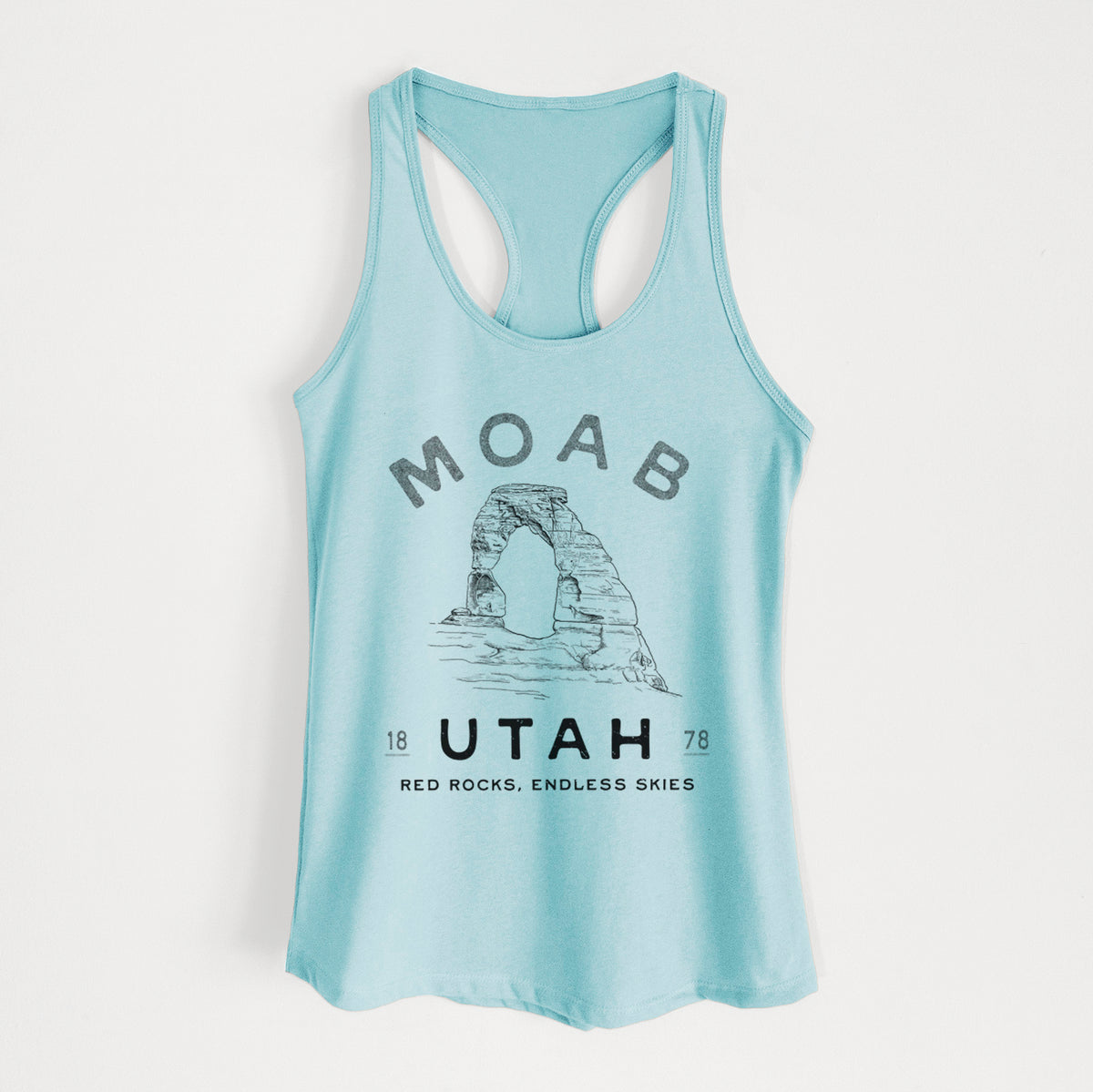 Cancun blue women's racerback tank top laid flat, printed with a black ink illustration of Delicate Arch with the words Moab Utah, 1878.