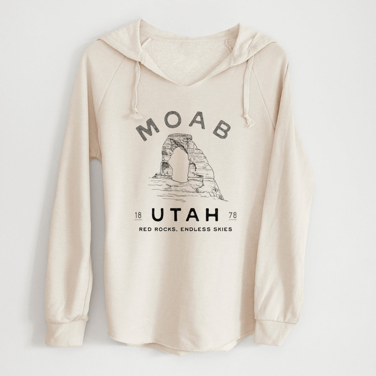 Bone cream women's Cali Wave hooded sweatshirt laid flat, printed with a black ink illustration of Delicate Arch with the words Moab Utah, 1878.