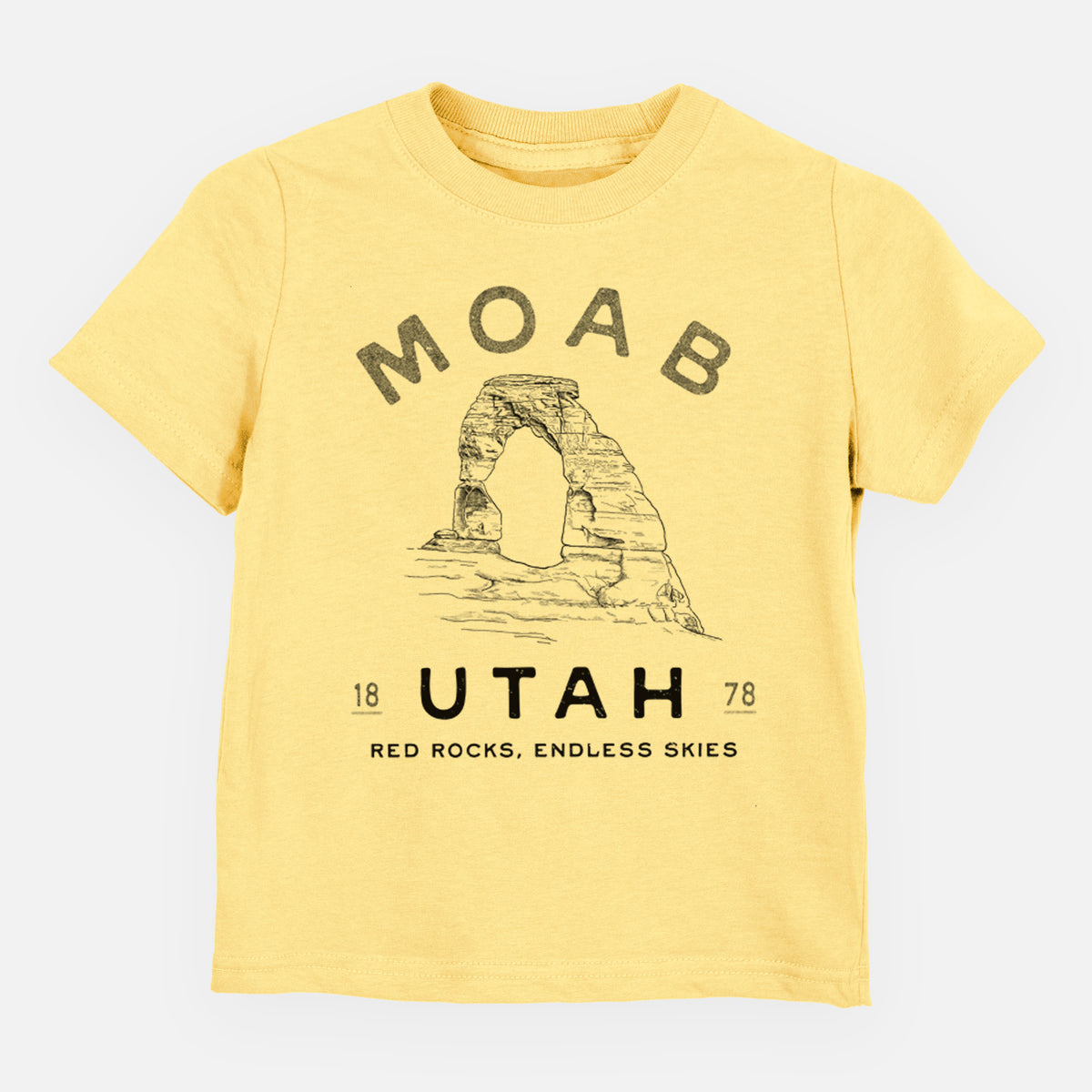 Butter yellow toddler t-shirt laid flat, printed with a black ink illustration of Delicate Arch with the words Moab Utah, 1878.