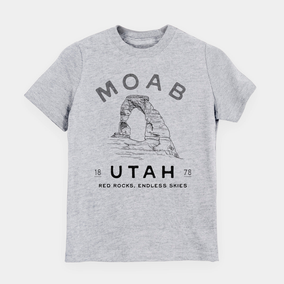 Heather grey youth t-shirt laid flat, printed with a black ink illustration of Delicate Arch with the words Moab Utah, 1878.