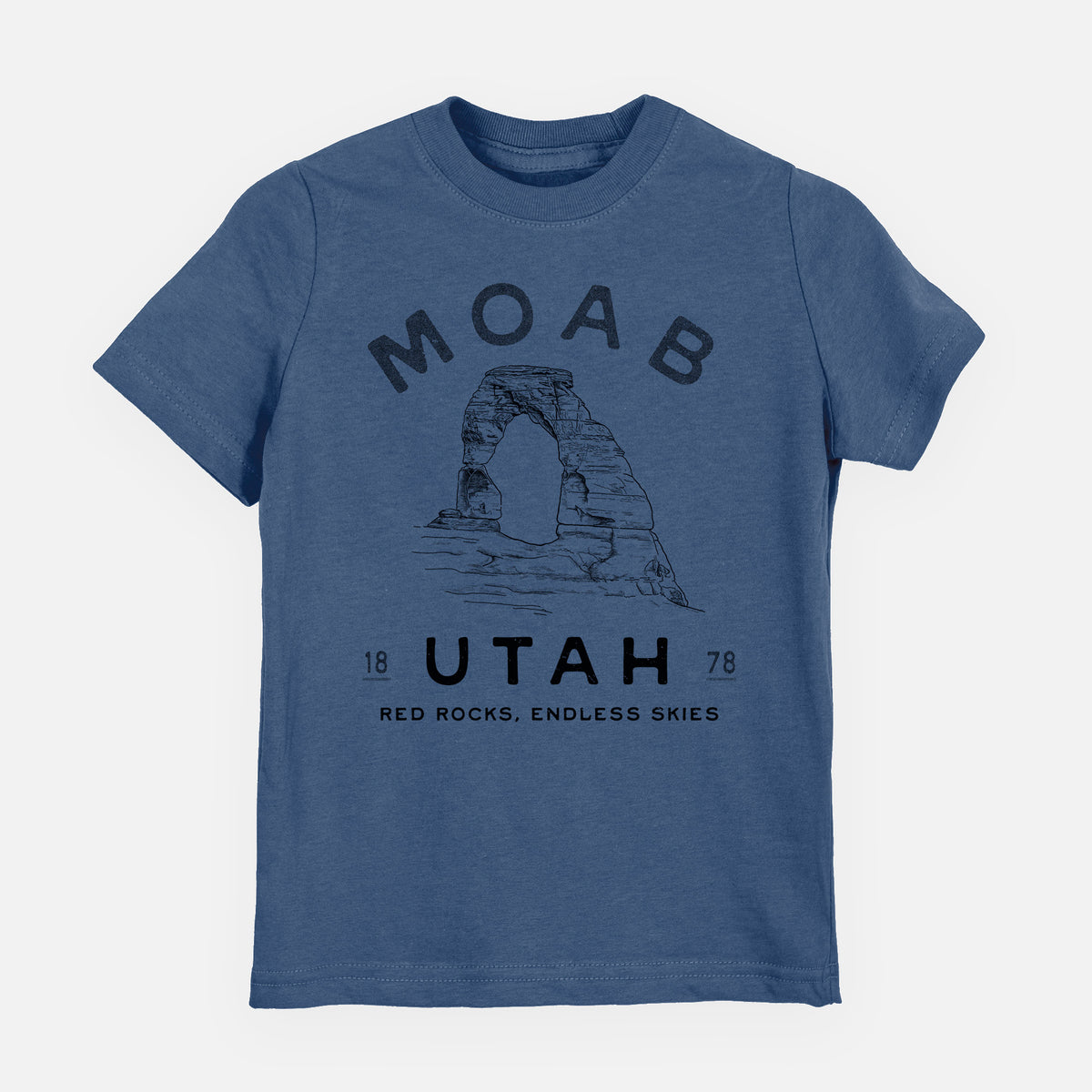 Indigo blue youth t-shirt laid flat, printed with a black ink illustration of Delicate Arch with the words Moab Utah, 1878.