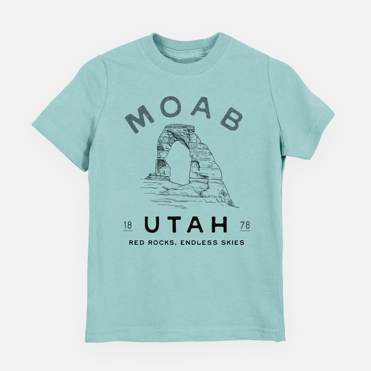 Saltwater youth t-shirt laid flat, printed with a black ink illustration of Delicate Arch with the words Moab Utah, 1878.