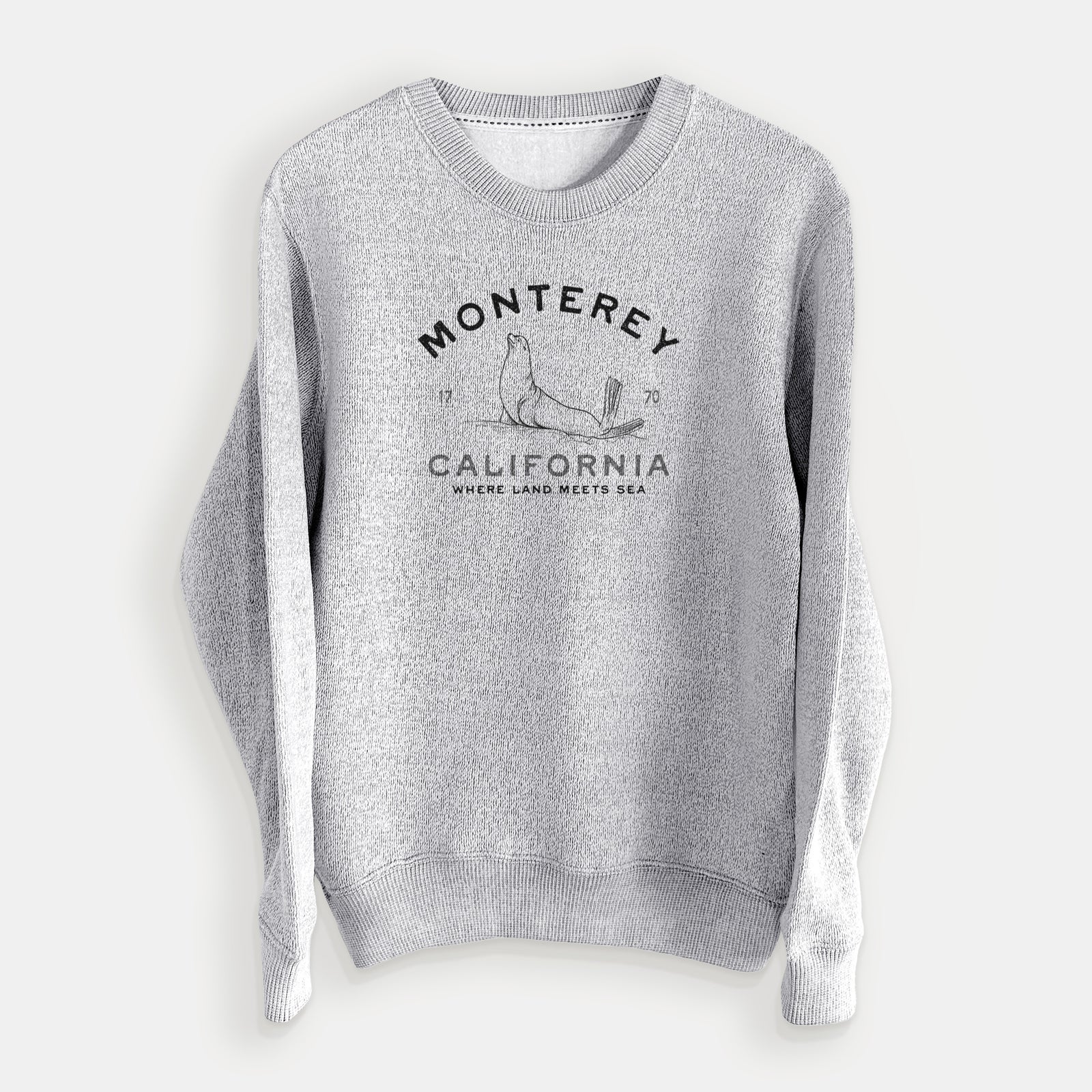Salt and pepper knit sweatshirt laid flat, printed with a black ink sea lion with the words Monterey California, 1770, Where Land Meets Sea.