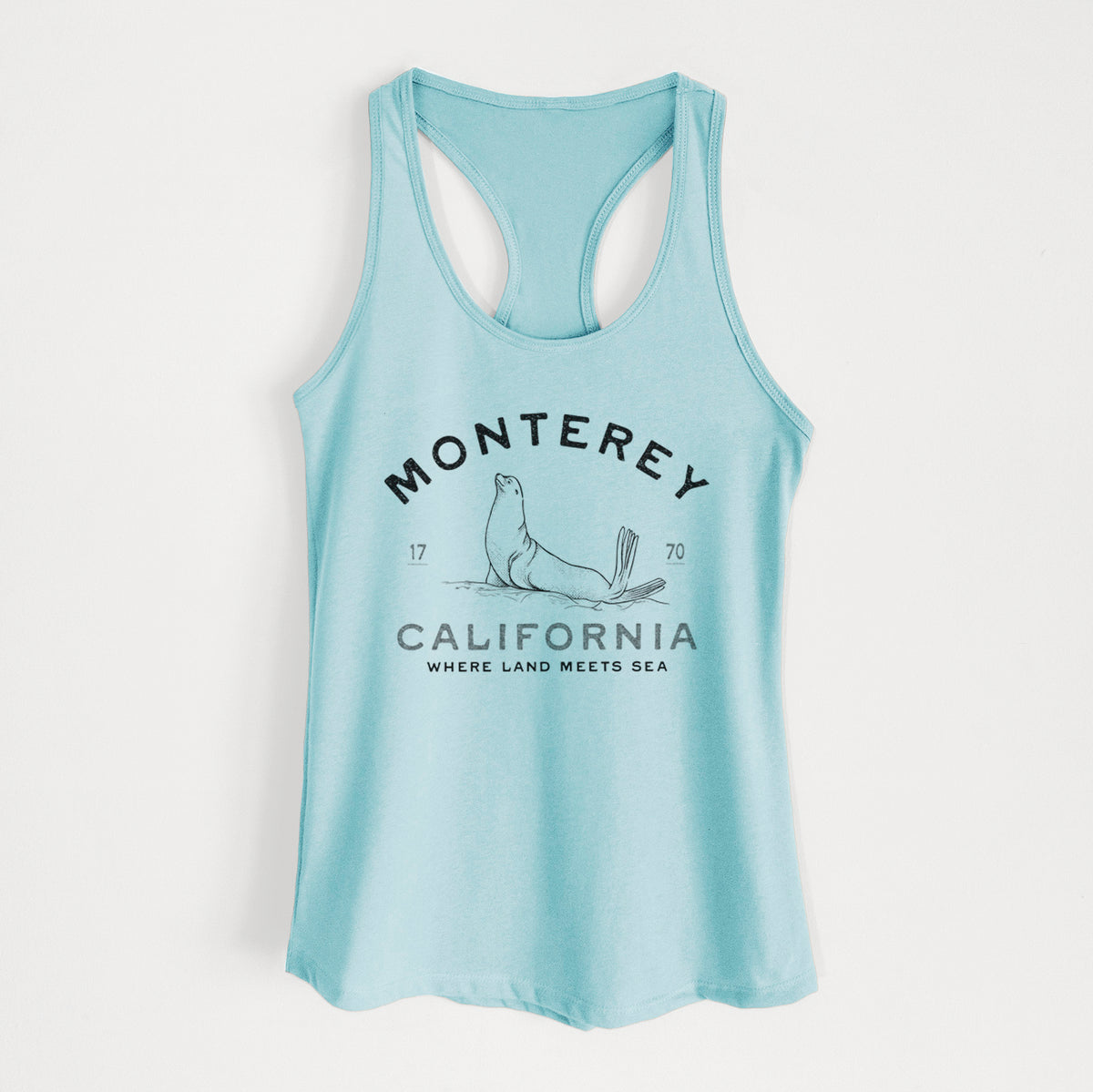 Cancun blue women's racerback tank top laid flat, printed with a black ink sea lion with the words Monterey California, 1770, Where Land Meets Sea.