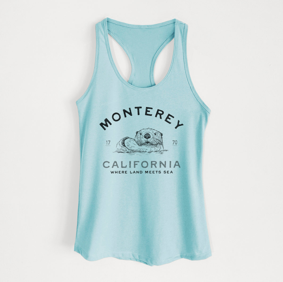 Cancun blue women's racerback tank top laid flat, printed with a black ink sea otter floating on its back, with the words Monterey California, 1770, Where Land Meets Sea.