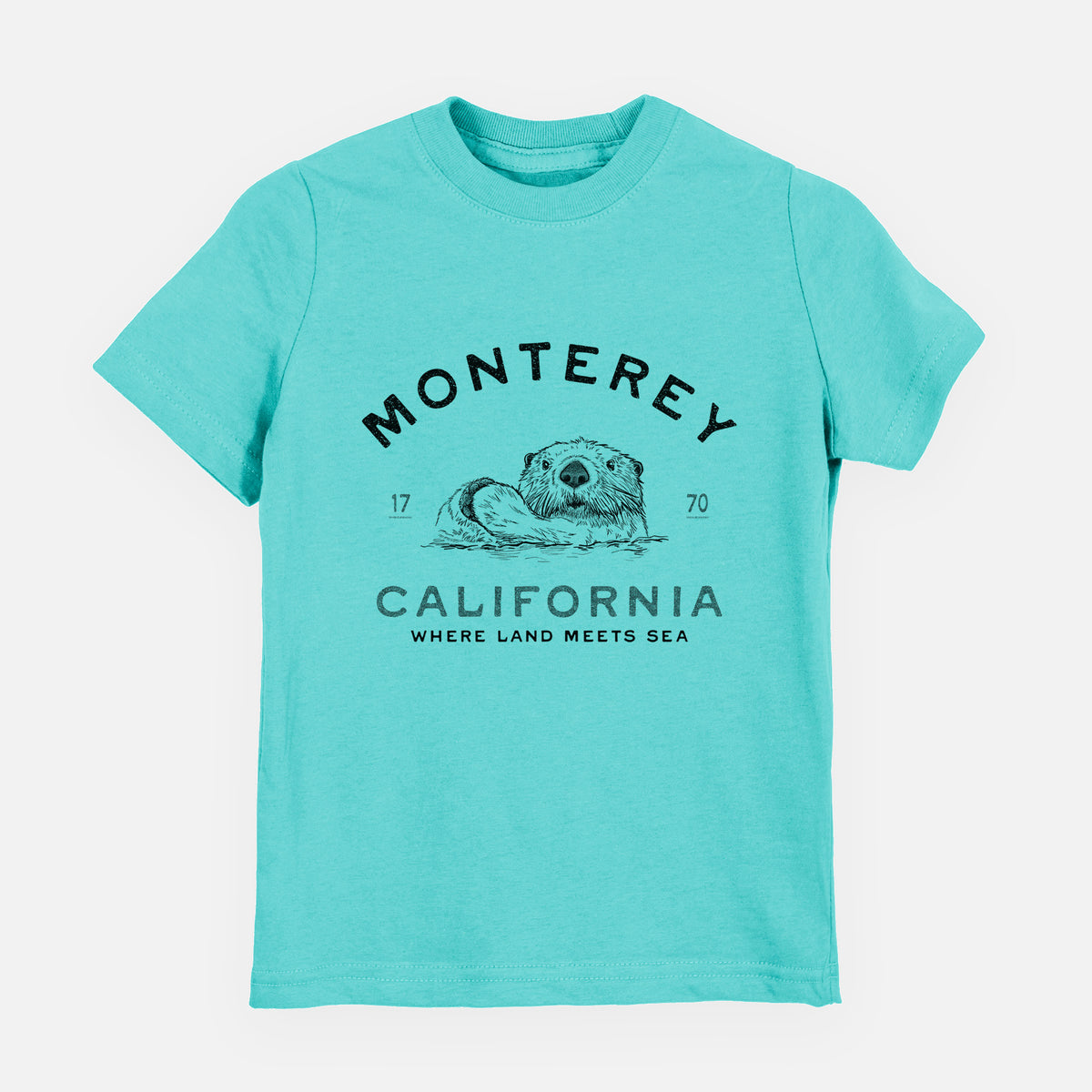 Caribbean blue youth t-shirt laid flat, printed with a black ink sea otter floating on its back, with the words Monterey California, 1770, Where Land Meets Sea.