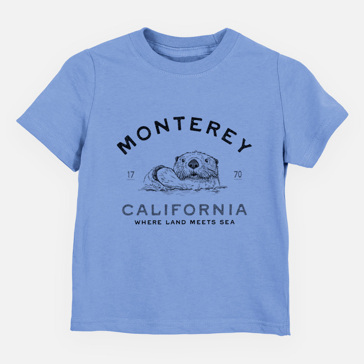 Carolina blue toddler t-shirt laid flat, printed with a black ink sea otter floating on its back, with the words Monterey California, 1770, Where Land Meets Sea.