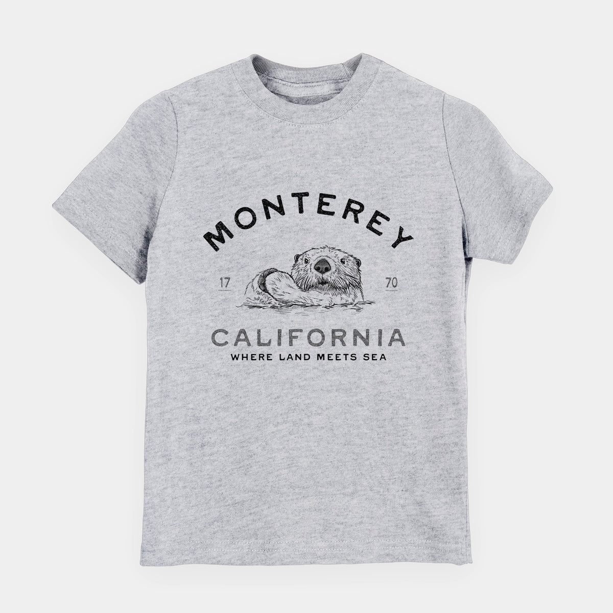 Heather grey youth t-shirt laid flat, printed with a black ink sea otter floating on its back, with the words Monterey California, 1770, Where Land Meets Sea.