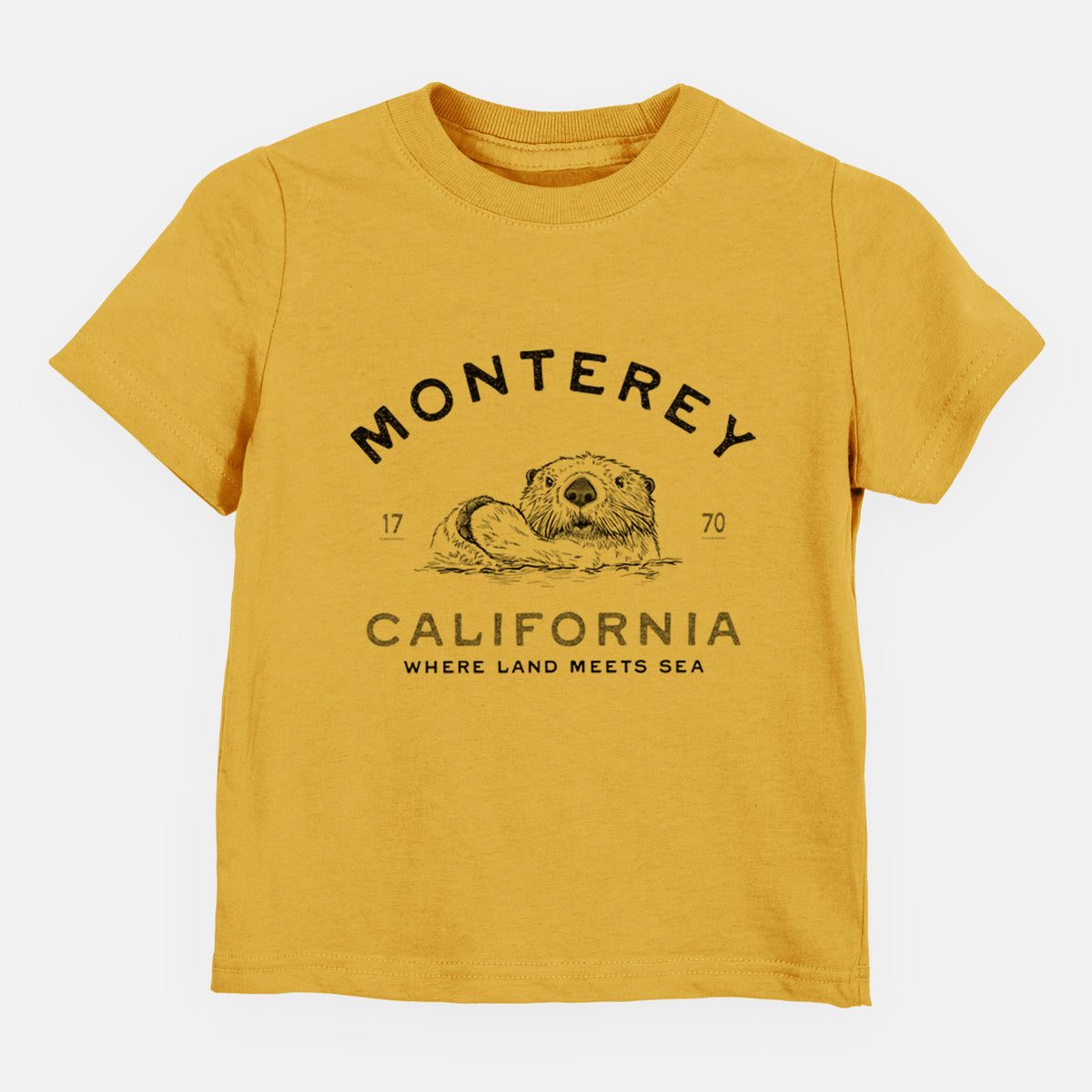 Honeycomb yellow toddler t-shirt laid flat, printed with a black ink sea otter floating on its back, with the words Monterey California, 1770, Where Land Meets Sea.